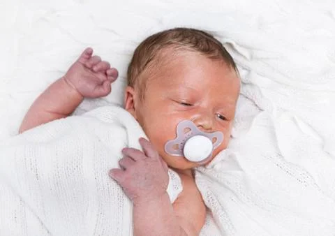 Infant with pacifier Stock Photos