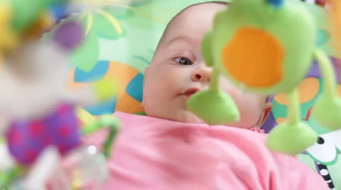 Infant on a play gym 2 Stock Footage 1075434