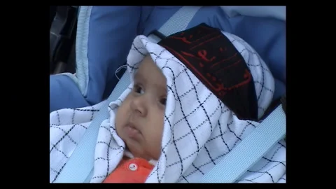 Infant in Stroller Wearing Keffiyeh During 2006 Tehran Rally Stock Footage 330957063