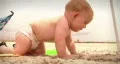 Infant toddler baby at summer beach with family playing in sand HD Footage