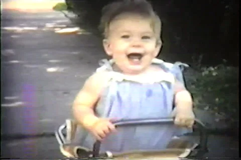 Infant in walker on sidewalk, 1968 Video stock 36089851