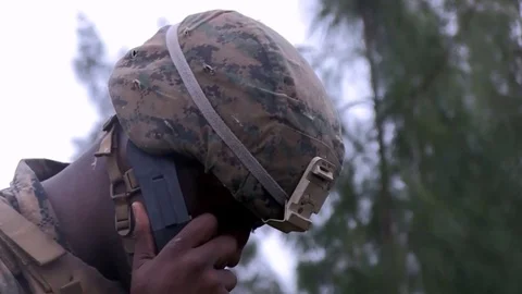 The infantry squad commander reports to the command over the telephone Video stock 120831987