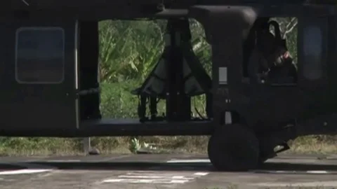 Infantryman jogging into a helicopter, evacuating Video stock 120831608