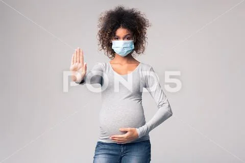 Infectious diseases and flu. Pregnant lady in medical mask Stock Photos