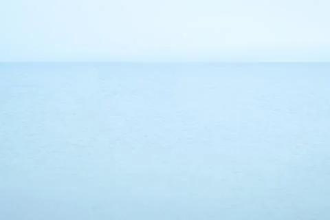 Infinite blue sea without objects and clouds Stock Photos