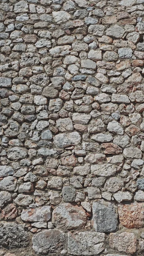 Infinite loop of a rustic stone wall texture scrolling vertically. Perfect Stock Footage 341138201