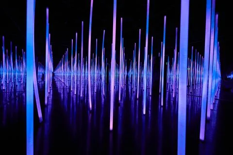 Infinity mirror room with blue LED light poles Stock Photos