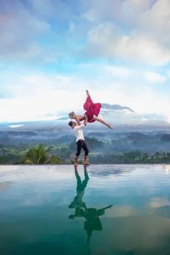 Infinity Pool Acrobatic Lift by Volcano in Bali Stock Photos