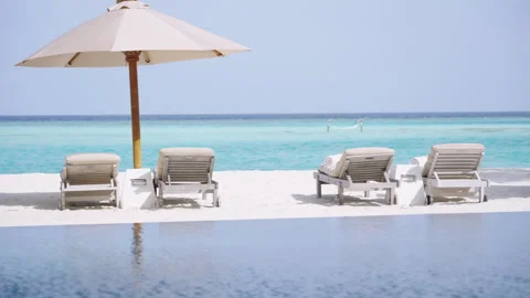 Infinity Pool and Beach Loungers at Gili Lankanfushi Maldives Stock Footage 340773040