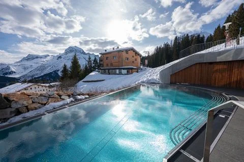 Infinity pool and spa beside pine forests in Oberlech, Austria Stock Photos