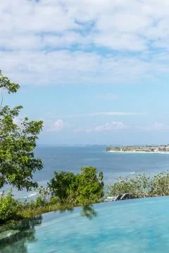 Infinity pool on the bright summer day. Bali island. Stock Photos