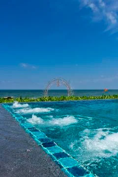 An infinity pool with jacuzzi at a beach resort Stock Photos