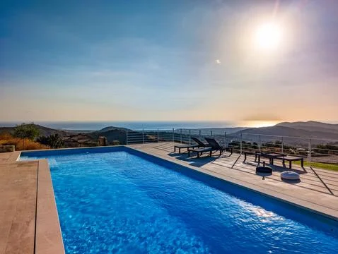 Infinity Pool Overlooking the Mediterranean Sea and Hills at Sunset  Luxury.. Stock Photos
