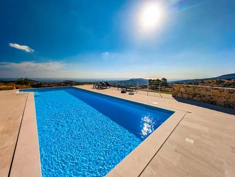 Infinity Pool Overlooking the Mediterranean Sea and Hills at Sunset  Luxury.. Stock Photos