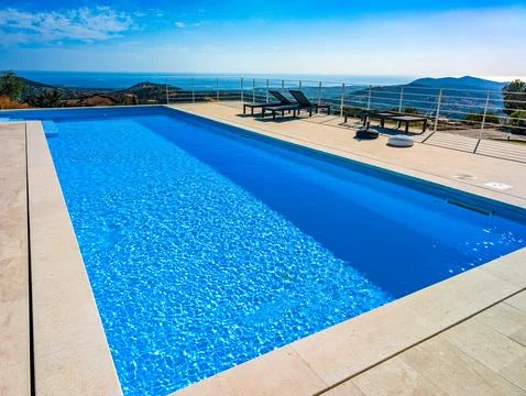 Infinity Pool Overlooking the Mediterranean Sea and Hills at Sunset  Luxury.. Stock Photos