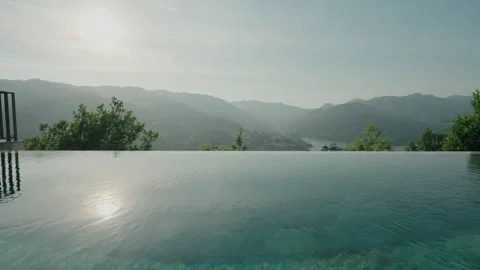 Infinity pool overlooking misty mountains and river valley at dawn Stock Footage 337913775