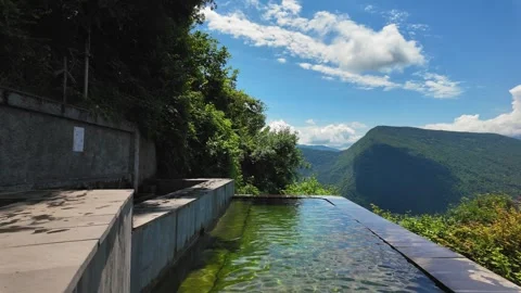 Infinity pool overlooking mountain valley landscape Stock Footage 344005181