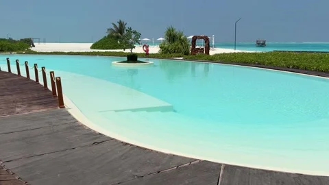 Infinity Pool Overlooking Turquoise Lagoon in Maldives Stock Footage 330883056