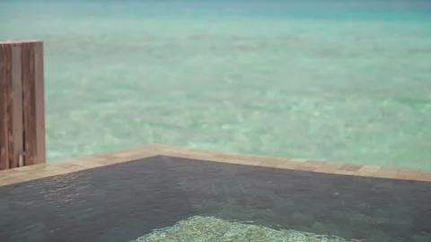 Infinity pool overlooking turquoise sea Stock Footage 329965783