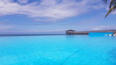 An infinity pool with a pontoon as a background Stock Photos