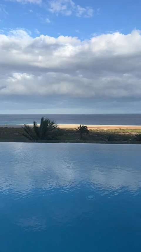 Infinity pool sky reflection ocean beach view Fuerteventura HD vertical Stock Footage 342027777