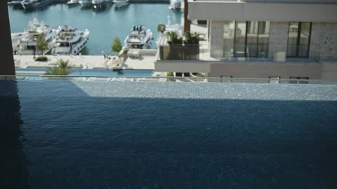 Infinity pool steps and Porto Montenegro marina in Tivat, Montenegro Stock Footage 329412190
