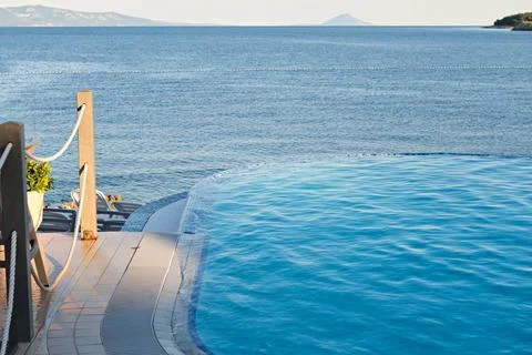 Infinity pool on the sunset Empty infinity pool on the sunset, quiet bue s... Stock Photos