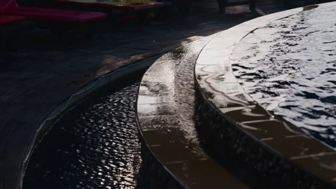 Infinity Pool Water Overflowing from Edge with Reflections Stock Footage 337533231