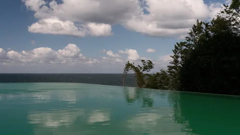 Infinity Pool Water Surface Reflecting Dramatic Clouds Video stock 347984715