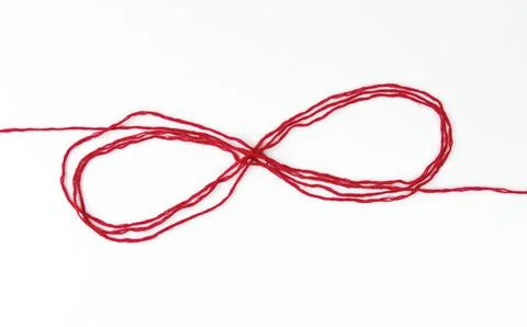 Infinity sign with red woolen threads, on a white background 스톡 사진