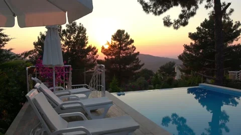 Infinity swimming pool area against sunset Stock Footage 134126850