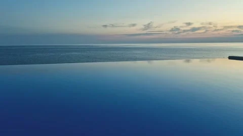 Infinity Swimming Pool Beach Sea Blue Sunrise Sky and Light Clouds Beautiful Air Stock Footage 287984447