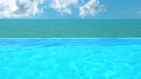 Infinity Swimming Pool with Clear Blue Water and Beautiful Resort Sea View on Su Video stock 230610532