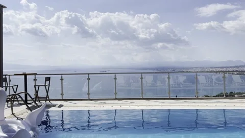 Infinity swimming pool with inflatable swan toys on the water Stock Footage 160784490