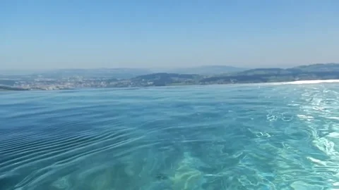 Infinity Swimming Pool with Mountain and Lake View in a Sunny Summer Day Vídeos de archivo 203526548