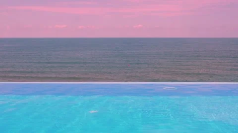 Infinity Swimming Pool Ocean Sunset Pink Blue Sky and Pink Clouds on the Horizon Video stock 318584375