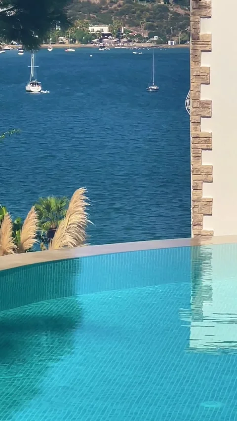 Infinity swimming pool view at luxury villa sea resort, calm crystal blue w.. Stock Footage 255218112