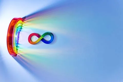 Infinity symbol with rainbow light spectrum on blue. Autism awareness, Stock Photos