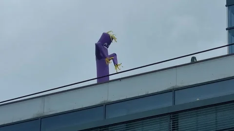 Inflatable Air Dancer Waving On A City Rooftop Stock Footage 343425542