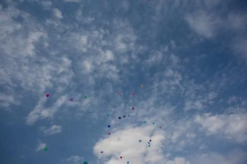 Inflatable balloons fly in the cloudy sky Stock Photos
