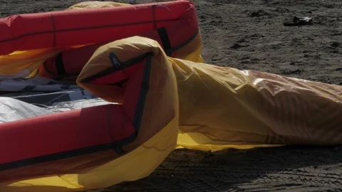 Inflatable bladders straighten up on beach sand slow motion Stock Footage 118993710