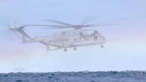 Inflatable boat and marines exiting CH-53 Super Stallion for helocast training Stock Footage 268207833