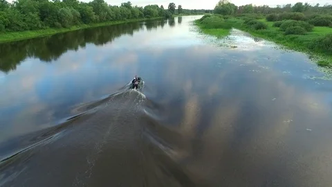 An inflatable boat with people floating on the river. Aerial view. Video stock 82471798