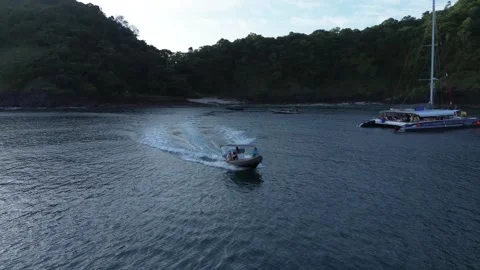 An inflatable boat takes guests back on board a private luxury yacht 動画素材 258143242