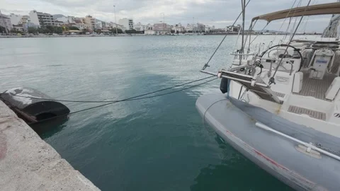 Inflatable Boat Tied to Sailboat in Empty Marina City Harbor Stock Footage 338109627
