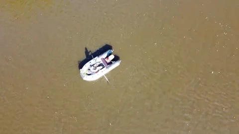 Inflatable boat top view, inflatable boat man rowing view from above, A man on a Stock Footage 318059382