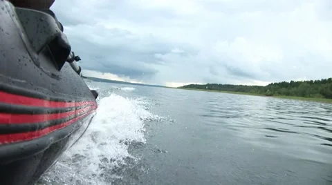 Inflatable boat. View from the side of a moving inflatable boat in cloudy wea 스톡 동영상 68945149