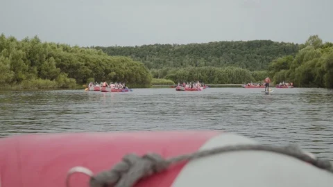 Inflatable boats float downstream of the mountain river Stock Footage 120491976