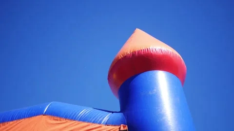 An Inflatable Bounce House over Clear Blue Sky Video stock 347033907