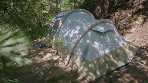 Inflatable Camping Tent Standing in Sunny Pine Forest Campsite Stock Footage 341989768